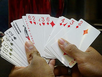 playing-cards-hands-holding-cards-clubs-hearts-jokers-gaming-cards-card-game-card-playing-card-mix-card-focus-thumbnail.jpg