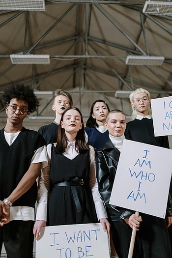 students, gym, placards, empowerment signs, Gen Z, diverse group, determined expressions, indoor setting, protest signs, activism, youth movement