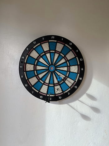 dartboard, white wall, darts, target, soft shadows, plain wall, blue dartboard, wall-mounted dartboard, dart game, indoor game, recreational activity