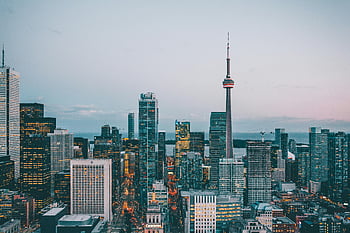 CN Tower, Toronto skyline, dusk view, iconic landmark, cityscape, urban landscape, evening lights, downtown Toronto, architectural marvel, travel destination, Canada