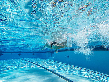 athlete swimming, underwater swimmer, crystal clear pool, freestyle technique, swimming pool, underwater photography, swimmer in action, pool lane, athletic swimmer, water sports, competitive swimming