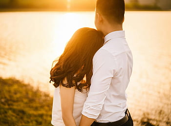 romantic couple, sunset by lake, love and togetherness, woman hugging man, body of water, romantic moment, couple at sunset, lake sunset, romantic scene, couple by lake, sunset couple
