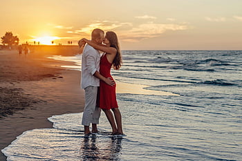couple kissing, beach, golden hour, sunset, seaside, vibrant sunset, romantic couple, beach couple, sunset beach, love embrace, ocean waves