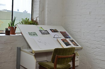 artist studio, sketches, plants, vintage style, creative inspiration, workplace, artworks, designer, quaint studio, drawing table, green chair