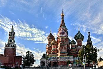 Kremlin, St. Basil's Cathedral, Moscow, clear blue sky, stunning view, Red Square, Russian architecture, Spasskaya Tower, historical landmark, cityscape, travel destination