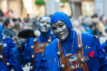 carnival parade, blue costumes, gray mask, cultural festivities, vibrant parade, participants in masks, blue outfits, festive event, cultural celebration, parade participants, blue attire