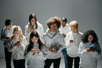 group of people, standing, using phones, diverse young adults, focused on smartphones, modern technology, digital connection, multi-ethnic group, smartphone addiction, technology usage, digital era
