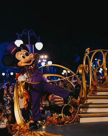 Mickey Mouse, festive costume, nighttime parade, Disney World, Disney parade, Mickey Mouse costume, nighttime Disney parade, Disney character, parade float, festive Mickey, Disney event