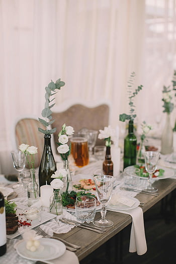 glasses on table, charming table setup, white flowers, glassware, wine bottles, event table, table decoration, dining table, event setup, table arrangement, white table setting
