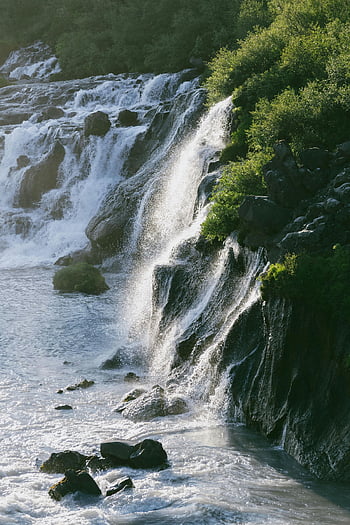 Cascades on Rocks, Iceland, Majestic waterfall, rocky terrain, lush greenery, natural landscape, waterfalls in Iceland, scenic waterfalls, outdoor scenery, nature photography, Icelandic waterfalls
