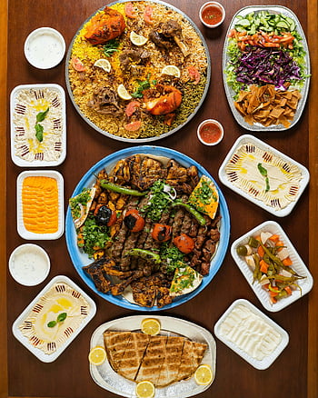 Middle Eastern dishes, grilled meats, rice, dips, flatlay, hummus, salad, pita bread, kebabs, falafel, tabbouleh