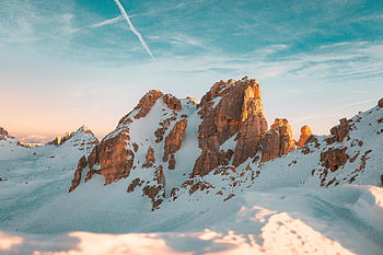 snow-covered mountains, dawn, clear sky, warm hues, winter landscapes, rock formation, snow, mountain peaks, natural scenery, alpine view, sunrise
