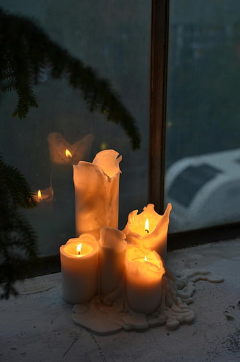 candles, windowsill, warm glow, indoor atmosphere, lit candles, bright wax, night scene, candlelight reflection, cozy ambiance, winter decor, snow background