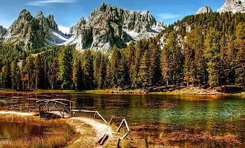 Dolomites, tranquil lake, autumn, rustic wooden bridge, serene view, body of water, mountain reflection, natural landscape, forested hills, alpine scenery, peaceful setting