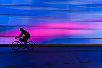 silhouette, person, riding, commuter bike, cyclist, colorful urban background, fitness, city life, motion blur, street scene, active lifestyle