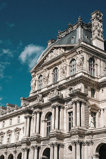 Louvre Museum, Paris, France, elegant facade, bright blue sky, architectural details, historical building, famous landmark, Paris attractions, European art museum, tourism destination