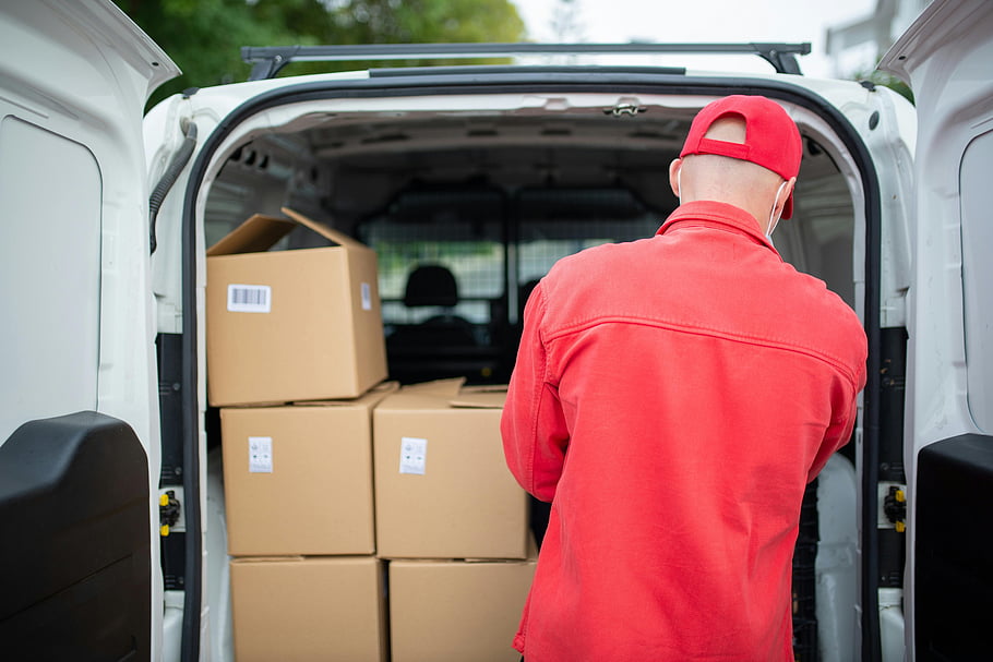 ier, red uniform, loading boxes, delivery van, cardboard boxes, outdoor scene, Portugal, delivery service, van interior, package delivery, worker in action