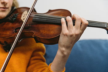 woman playing violin, close-up shot, violin strings, hands on violin, musical instrument, violinist, string instrument, music performance, detailed view, musical artistry, female musician
