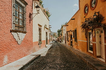 San Miguel de Allende, colorful colonial architecture, quaint street, Mexico, cobblestone street, colonial houses, vibrant buildings, historic city, Mexican architecture, street scene, colonial charm