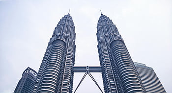 Petronas Twin Towers, Kuala Lumpur, Malaysia, iconic skyscrapers, bright sky, modern architecture, city skyline, urban landscape, tall buildings, travel destination, landmark