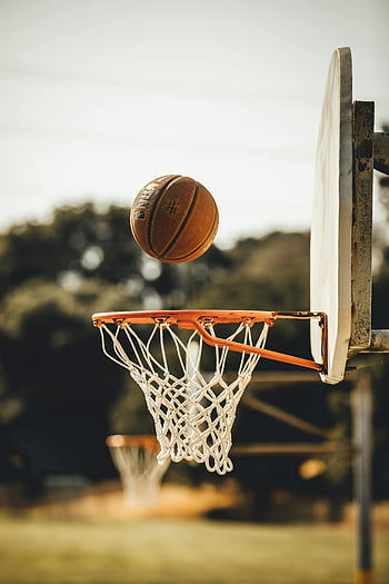 basketball, hoop, outdoor court, San Francisco, dynamic sports moment, ball above hoop, basketball ring, sports action, outdoor basketball, net, backboard