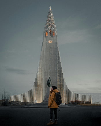 Hallgrimskirkja Church, Reykjavik, twilight, yellow jacket, person standing, Iceland architecture, urban landscape, religious building, travel photography, winter scene, statue