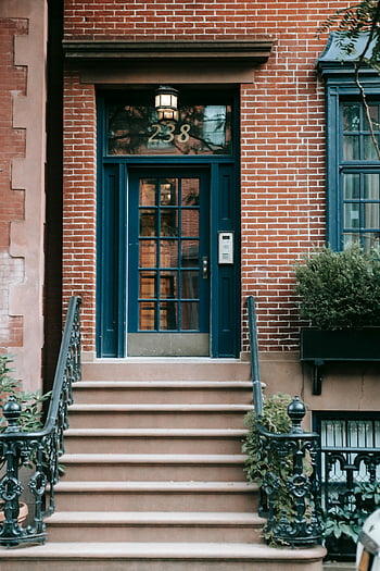 brick townhouse, blue door, elegant entrance, staircase, exterior building, doorway, steps, brick facade, townhouse entrance, front door, urban architecture