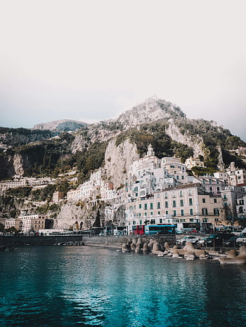 Positano, Amalfi Coast, vibrant buildings, stunning cliffs, body of water, rocky mountain, picturesque scenery, coastal town, Mediterranean landscape, Italian coast, seaside village
