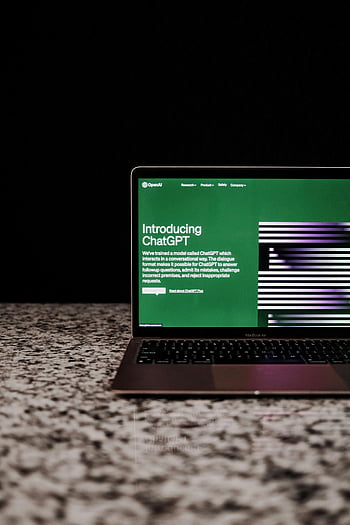 laptop, ChatGPT, AI technology, marble surface, computer screen, OpenAI, interface, digital display, modern technology, workspace, productivity tool