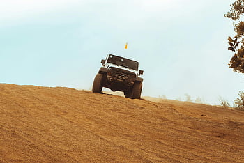 white SUV, dirt road, off-road, sandy slope, rugged vehicle, adventurous journey, outdoor adventure, vehicle on slope, off-road vehicle, white sport utility vehicle, sandy terrain