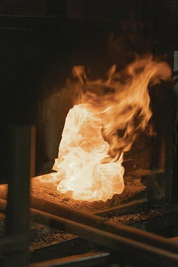melting steel, bright flame, traditional blacksmith, forge, intense heat, close-up, blacksmithing, fire, metalworking, furnace, craftsmanship