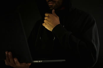 hacker, laptop, pensive, touching chin, cybercrime, anonymity, man in hoodie, darkness, computer, technology, cyber security