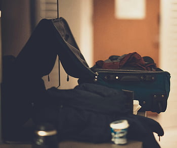 travel luggage, blue suitcase, open suitcase, clothes packed, indoor image, warm tones, travel readiness, packed clothes, travel preparation, luggage contents, travel essentials