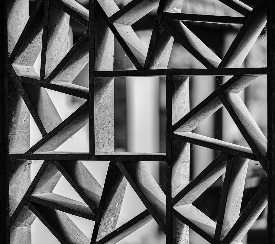 window, black and white, mosaic, stone, geometric pattern, courtyard view, architectural detail, monochrome, abstract design, structural element, outdoor scene