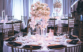 wedding dining setup, floral centerpieces, candlelight ambiance, pink and white roses, elegant table setting, luxurious wedding, dining table, wedding reception, floral arrangement, wedding decor, candlelight dinner