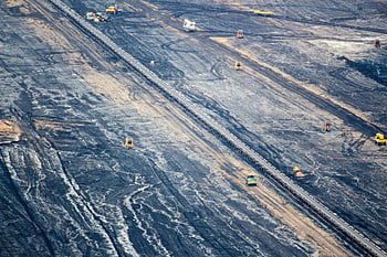 aerial view, large empty construction site, expansive open-pit mine, industrial mining operations, Inden Germany, aerial perspective, mining site, construction site, open-pit mining, industrial site, aerial photography