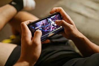 mobile gaming, League of Legends, smartphone gaming, gaming lifestyle, technology lifestyle, close-up view, person playing, video game, mobile video game, gaming technology, hands holding phone