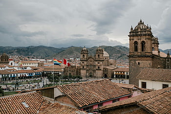 Cusco Peru, medieval church, old tile roof, Plaza de Armas, Cathedral of Cusco, Andean mountains, aerial view, cityscape, historic buildings, traditional architecture, flags