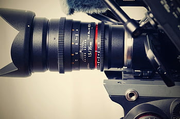 Black camera, zoom lens, close photography, professional camera, lens focus ring, detailed close-up, camera lens, focus settings, photography equipment, camera gear, professional photography