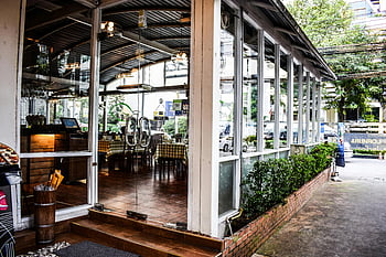 modern restaurant, large glass windows, contemporary interior design, restaurant entrance, architectural photography, urban dining, outdoor seating, modern dining space, restaurant facade, glass facade, contemporary restaurant design