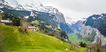 Lauterbrunnen, Switzerland, small settlement, mountain slope, spectacular valley, lush green valley, snow-capped mountains, scenic landscape, alpine scenery, Swiss Alps, rural village