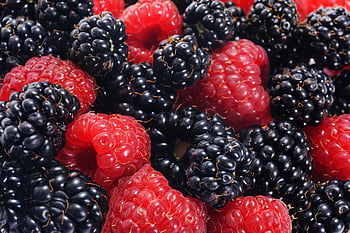 red raspberries, black raspberries, blackberries, vibrant colors, fresh berries, close-up, natural textures, black surface, fruit photography, berry textures, berry colors