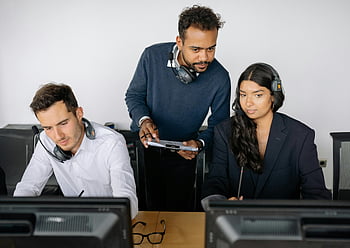 man and woman, computer screen, office team, headset collaboration, working on project, business people, professional setting, teamwork, technology use, office environment, project discussion