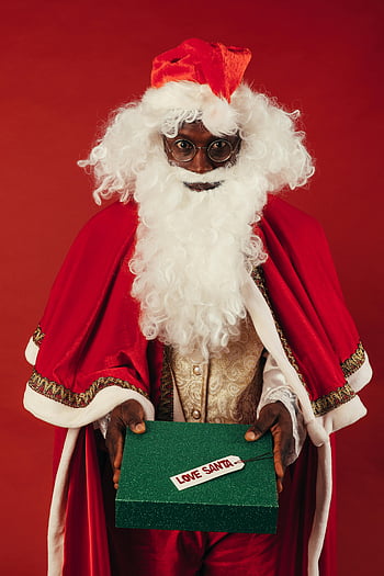 African American Santa Claus, green Christmas present, festive red backdrop, gift box, Santa Claus, Christmas, holiday, African American, Santa, festive, red background