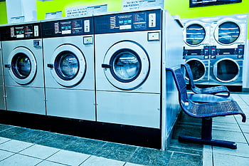 gray front load washing machines, contemporary laundromat, self-service washing machines, Los Angeles laundromat, front-loading washers, laundry room, public laundry, coin-operated machines, laundry equipment, tiled floor, metal chairs