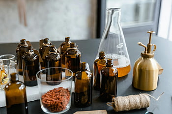 tilt shift lens, glass bottles, essential oils, aromatherapy, herbs, amber bottles, beaker, spray bottle, twine, table setup, indoor photography