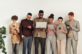 people using gadgets, diverse group, adults, interacting devices, stylish office, modern technology, laptops, smartphones, tablets, technology use, office setting