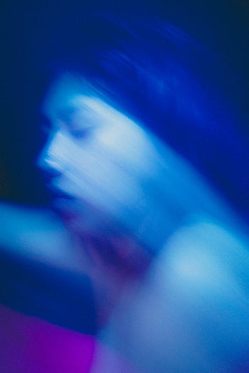 blue defocused headshot, blurred portrait, motion blur, blue lighting, abstract effect, artistic portrait, defocused photography, blue tones, abstract photography, blurred headshot, artistic headshot