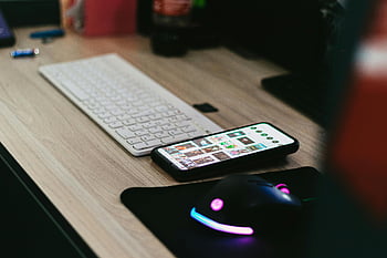 cell phone, mouse, keyboard, desktop setup, smartphone, RGB mouse, sleek design, vibrant mouse, tech setup, modern desk, office equipment