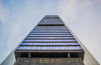 worm's eye view, gray building, modern skyscraper, glass windows, clear sky, architectural innovation, low angle view, urban architecture, contemporary design, cityscape, tall structure